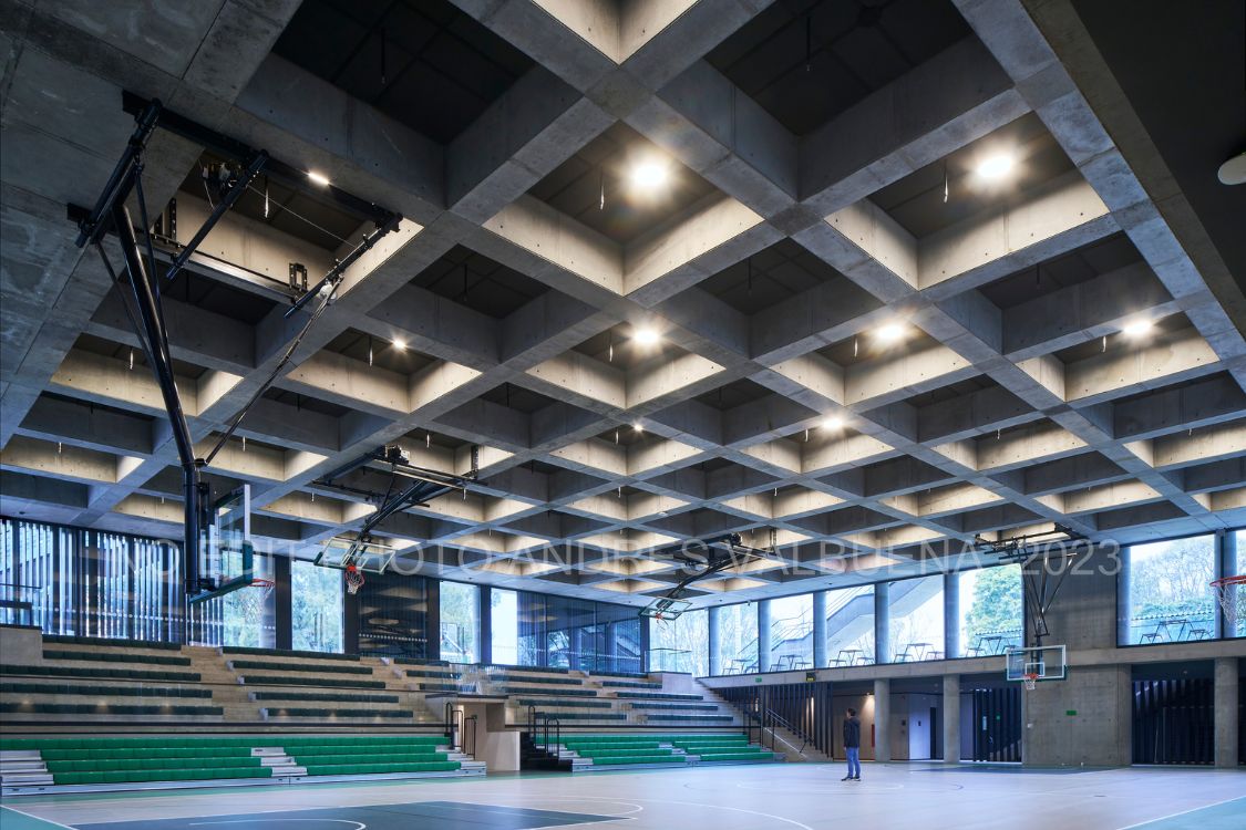 Gimnasio Moderno School Coliseum - Interior basketball court highlighting the exposed concrete coffered ceiling - Felipe Gonzalez Pacheco.jpg